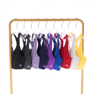 Colorful bras on a gold rack against a white background
