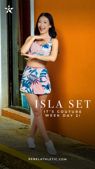 Woman wearing a colorful athletic outfit with 'Isla Set' branding against an orange wall.