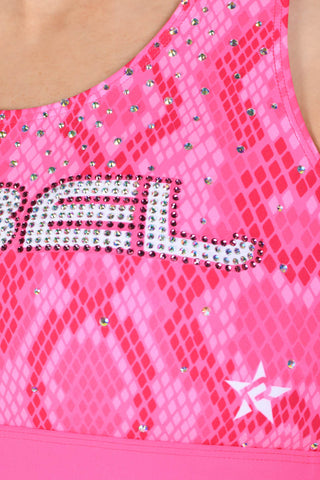 Close-up of a bright pink athletic top with a diamond-patterned mesh, rhinestone embellishments, and a large rhinestone lettering graphic across the chest.