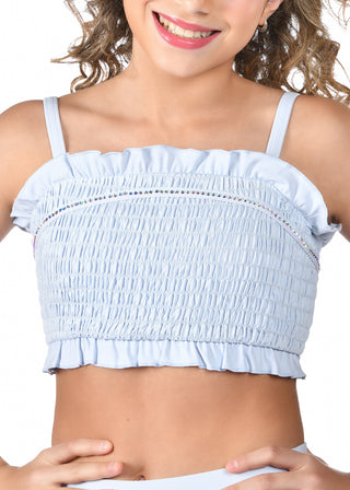 Light blue smocked crop top worn by a person on a white background