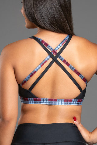 back of black sports bra with red and white plaid straps
