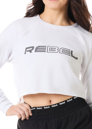 Person wearing a white sweatshirt with 'REBEL' text and black pants with 'REBEL' waistband.