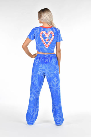 Person wearing a blue outfit with a heart design on the back against a white background