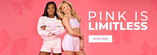 Two models posing in pink clothing against a pink background with the text 'PINK IS LIMITLESS' and a 'SHOP NOW' button.